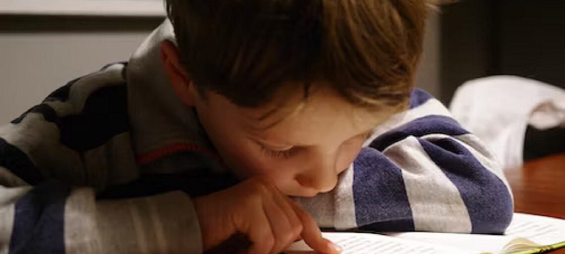 Smiling child reading a book at a dyslexia center