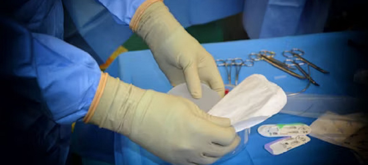 Person following postoperative guidelines after carpal tunnel surgery, resting with elevated hand.