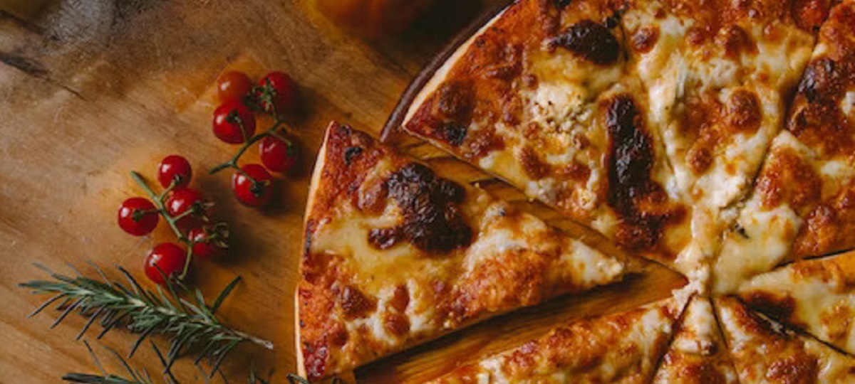 A person enjoying a homemade, mindful pizza as part of ulcerative colitis management, featuring a gluten-free crust and lactose-free cheese.