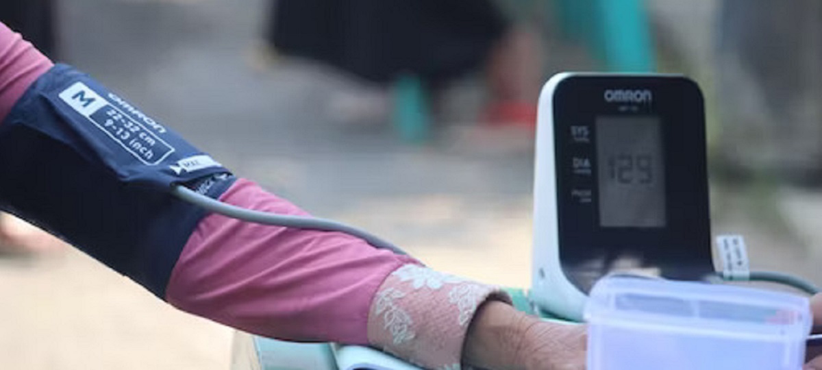 Close-up of a blood pressure monitor displaying 180/120 mm Hg, representing stroke level blood pressure.