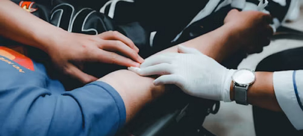 Nurses assessing a patient with appendicitis, checking vital signs and abdominal tenderness